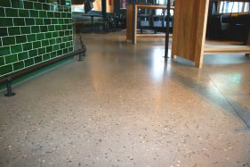 Polished concrete with exposed aggregate in restaurant